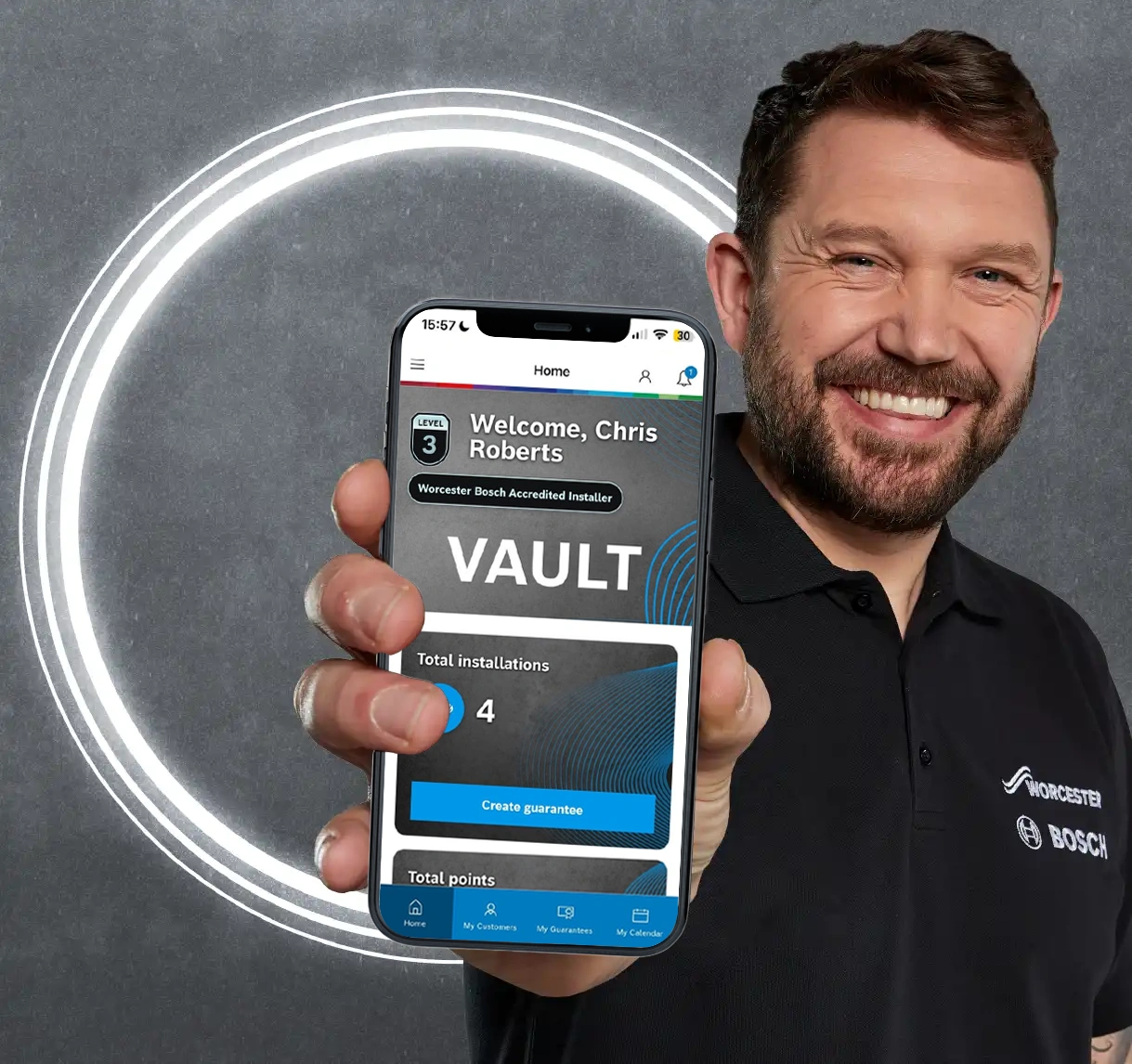Installer holding phone showing VAULT on app